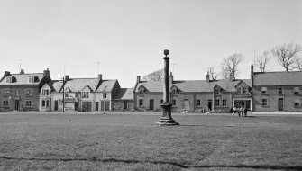 General view of north side of the Green, Swinton village showing the market cross