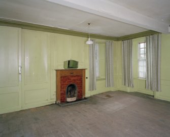 Interior.View of ground floor South room/ parlour from North showing the fireplace and panelling