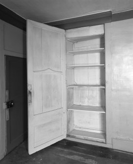 Interior.View of ground floor South room/ parlour from North showing a detail of the cupboard concealed behind panelling to the East of the fireplace formed in a blocked window embrasure.
