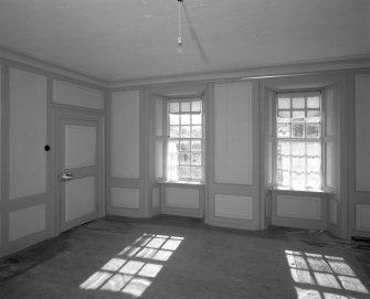Interior.View of ground floor/ North room dining room from West showing windows, two panelled door and panelling
