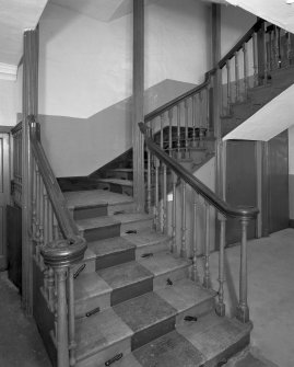 Interior. View of half turn with landings staircase at ground floor level showing fluted newel posts and turned balusters