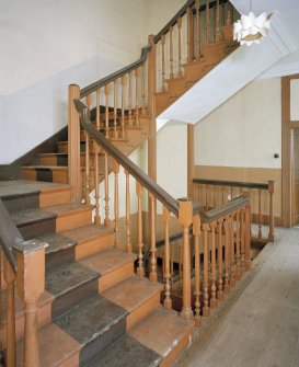 Interior. View of half turn with landings staircase at first floor level showing fluted newel posts and turned balusters