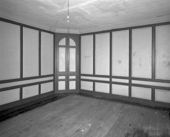 Interior. View of first floor South room/ drawing room from West showing closed china closet and panelling