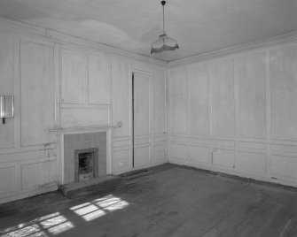 Interior. View of first floor North room/principal bedroom from South showing panelling and fireplace