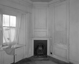 Interior.View of first floor South East room from West showing panelling and fireplace
