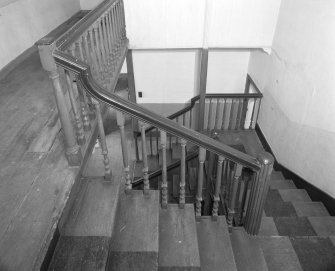 Interior. View of half turn with landings staircase at second floor level showing fluted newel posts and turned balusters looking downwards