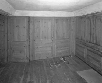 Interior. View of second floor East room/housekeepers room from North showing fitted cupboards closed.