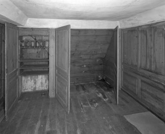 Interior. View of second floor East room/housekeepers room from North fitted cupboards open.