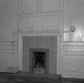Interior. View of first floor North room/principal bedroom from South showing panelling and fireplace