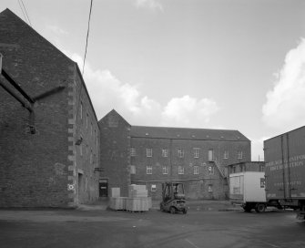 Selkirk, Dunsdale Haugh, Dunsdale Road, Riverside Mills
View from north east of north east side of original spinning mill, showing its 'T'-shaped plan, its north-east leg being partly visible to the left, and north-west leg to the right . At the time of the survey, the mill was used predominantly as a warehouse.