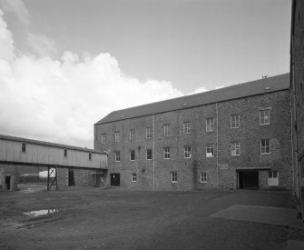 Selkirk, Dunsdale Haugh, Dunsdale Road, Riverside Mills
View from south of south west side of original spinning mill, showing its 'T'-shaped plan, its north-west leg being visible to the left, and part of the south-west leg to the right . At the time of the survey, the mill was used predominantly as a warehouse.