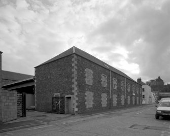General view from N showing Roxburgh Street facade.  The building in the foreground was occupied in recent years as a fire station.
