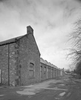 Oblique view from S of SE side of main block of mill.