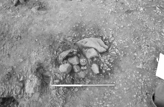 Excavation photograph : area I - stones f167 with fill 166 in cut 168, from S.