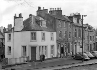 View of 5 and 6 Abbey Place, Jedburgh from west, showing Abbots Lea and T Cairncross confectioner and tobacconist.