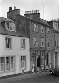 View of 5 and 6 Abbey Place, Jedburgh, from west, showing part of Abbots Lea and T Cairncross confectioner and tobacconist.