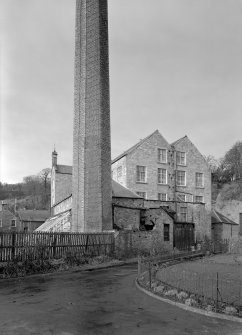 View of main building and engine house with chimneystack, Bongate Mill, Jedburgh, from east