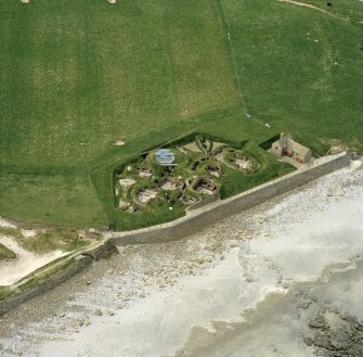 Oblique aerial view centred on the prehistoric settlement at Skara Brae