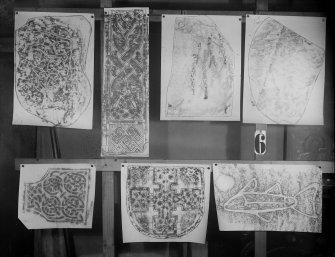 Photographic copy of seven rubbings showing Burghead no.2 Pictish symbol stone and a cross fragment from St Mary’s Chapel, Aberlady at the top left. The remaining carved stones are unidentified.