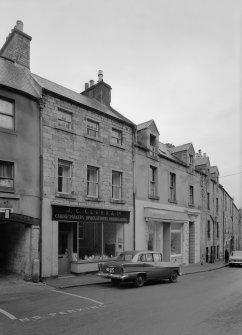 View of south elevations of 14-18 Canongate, Jedburgh from west, showing the premises of Robert Douglas and J C Clark & Co cabinetmakers, upholsterers and undertakers.