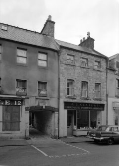 View of 12-14 Canongate, Jedburgh, from south west showing the premises of J C Clark & Co cabinetmakers, upholsterers and undertakers and the pend to Crown Lane.