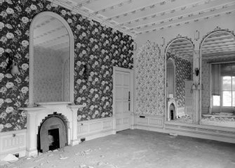 Interior view of Rockville, 3 Napier Road, Edinburgh, showing a room with large arch-topped mirrors, a ribbed ceiling with gilded flowers, a fireplace with a stepped interior arch and wallpapers with design of cabbage-roses and vases.