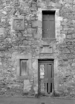 Detail of south elevation of 40 Canongate, Jedburgh, showing main entrance doorway and plaques.