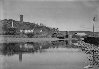 View of Ballantrae village showing the bridge, toll house and war memorial and the remains of Ardstinchar Castle.