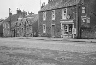 View of 41-47 Willoughby Street, Muthill showing St Ann's, Hall Cottage and M B Cow tobacconist and confectioner in Crombie House, with children at entry to Community Hall.