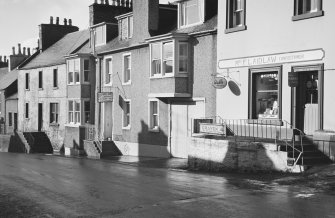 View of 65-69 Main Street, Glenluce, from north east, showing Auld King's Arms and Mrs. F. Laidlaw Confectioner.