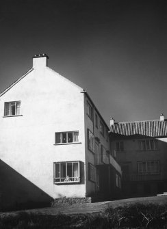 Dunbar, Victoria Street, Harbour Housing.
Photographic view of three-storey courtyard block from verge.
Stamped on verso: 'J. Roman Rock, 22 Brandon Terrace, Edinburgh 3'.