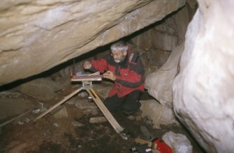 Eigg, Struidh, Ritual Enclosure. Ian Parker undertaking a plane table survey of 'The Oracle' chamber.