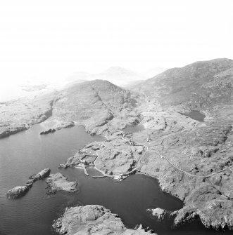 Oblique aerial view of Rodel, Harris, showing a distant view of St Clement's Church.