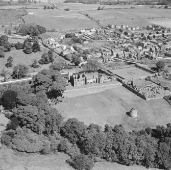 Oblique aerial view of Aberdour village, showing Aberdour Castle and dovecot and St Fillan's Church
