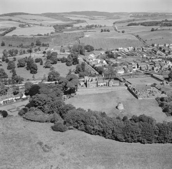 Oblique aerial view of Aberdour village, showing Aberdour Castle and dovecot and St Fillan's Church
