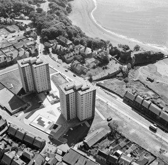 Oblique aerial view of Ravenscraig Castle and Pathhead tower blocks, Kirkcaldy from north west.