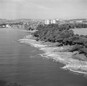 Oblique aerial view of Ravenscraig Castle and Pathhead tower blocks, Kirkcaldy from north east.