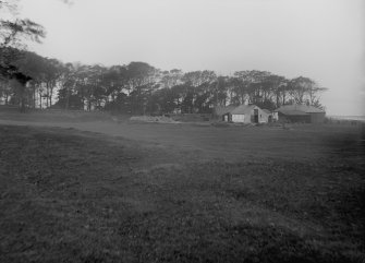 Photograph recording the site of Granton Gasworks, Edinburgh, prior to construction, looking NW towards the buildings in the NW corner of the site.