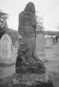 View of gravestone sculpture of mother and child (no name) in the churchyard of St Columba's Old Parish Church, Kirkcolm.