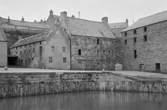 View of warehouse at 10 Shorehead and harbour wall, Portsoy.