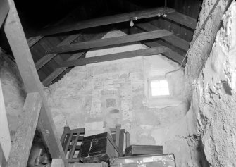 Interior view of Corsindae House showing fireplace in attic of old part of house.
