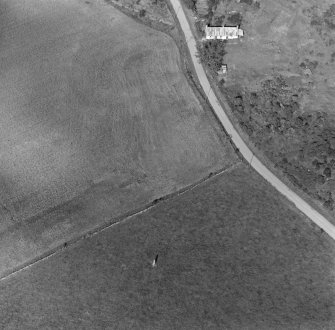 Oblique aerial view of Clach Chairidh Pictish symbol stone, Ederton and the site of Carriblair stone circle.