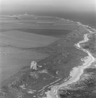 Oblique aerial view of Ballone Castle and Tarbatness lighthouse in the distance.