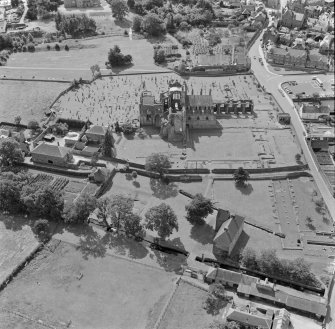 Oblique aerial view centred on Melrose Abbey.
