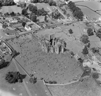 Oblique aerial view centred on Melrose Abbey.