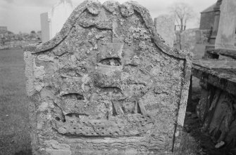 Detail of gravestone with a ship in the churchyard of Collace Old Parish Church.