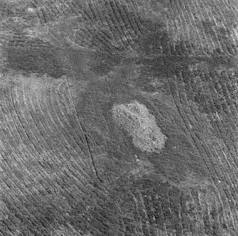 Oblique aerial view centred on the chambered cairn at Carn Ban, Arran.
