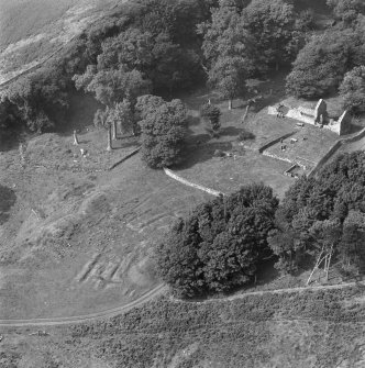 Oblique aerial view centred on the remains of St Blane's Church and burial ground, Bute, taken from the N.