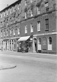 View of 4-16 Chapel Street, Edinburgh from south east showing the Caledonian Loan Office, Maison Bartlett ladies' hairdresser and a Post Office.