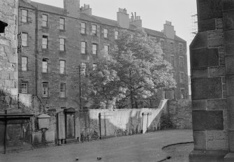 View of the churchyard of Buccleuch Parish Church, Edinburgh, seen from the north north east with the rear of the north side of Buccleuch Place, Edinburgh in the background.